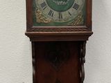 a grandfather clock that is on the wall by the wall