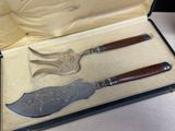 two knives and a knife in a box on a table