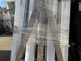 a large pile of windows wrapped up in plastic
