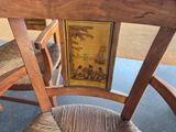 a wooden chair with a picture on the back of it