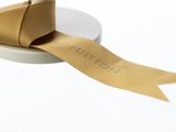 a roll of brown ribbon on top of a white plate
