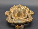 an antique brass figurine of a man with a hat on his head