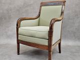 an old chair with a green and white upholstered upholstered seat