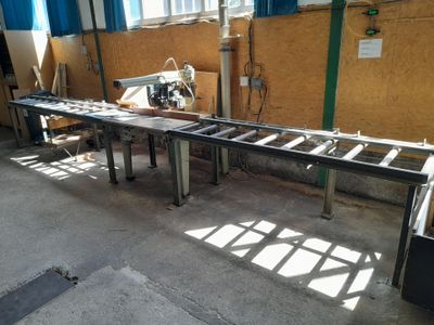 an image of a factory with a long table in the middle of the room