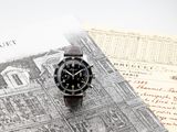 a watch sitting on top of a piece of paper on a table