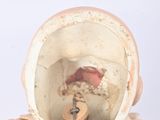a doll that is wearing a gold dress and a hat