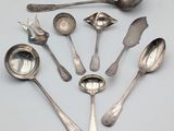 a lot of silver spoons and spoon spoons on a table