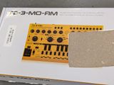 a cardboard box with an electronic device inside of it