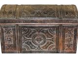 an old wooden chest with intricate carvings on the sides