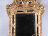 a gold frame with a mirror in it on a white surface