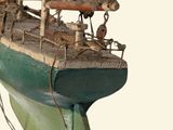a wooden model of a boat on display on a table