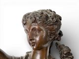 a statue of a woman holding a bird in her hand