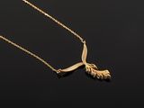 a gold necklace with a bird on it ' s neck