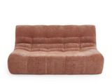 a brown couch sitting on top of a white floor next to a white wall
