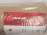 a roll of interbeds wrapped in plastic on a table