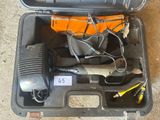 a tool in a case that is sitting on the ground