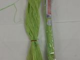 a green rope and a plastic tube on a white table