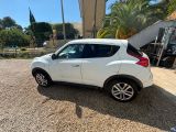 a white car parked in a parking lot next to a building