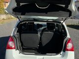 a white car with its trunk open on the street