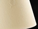 a close up of a lamp with a white shade on it