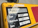 a yellow sign that is on the side of a table