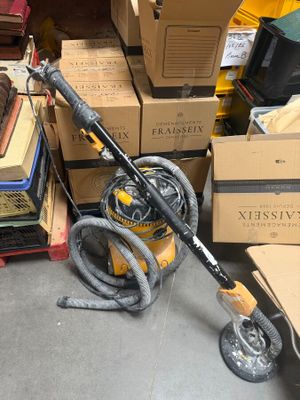 a vacuum that is sitting on the floor in front of a pile of boxes