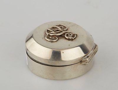 an image of a small silver box with a dragon on it