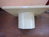a white toilet sitting on the floor next to a pink wall