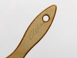 a wooden spoon with a wooden handle on a white surface