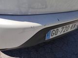 a close up of a car ' s bumper with a number plate on it
