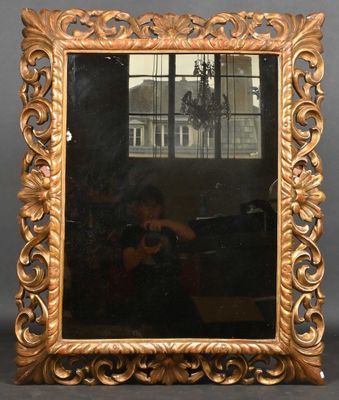 an ornate gold framed mirror with a man taking a picture