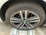 tire of a white car with a flat tire on the side of the road