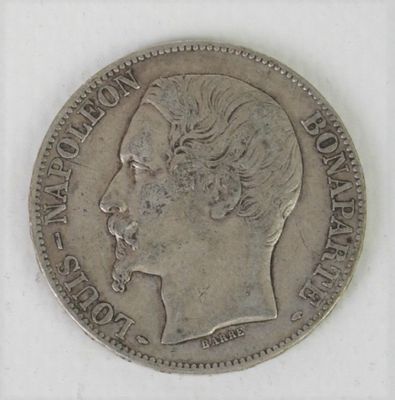 a close up of a coin on a white surface