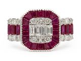 a close up of a diamond and ruby ring on a white background