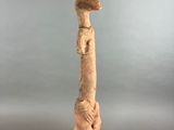 a sculpture of a giraffe standing on top of a black base