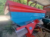 a blue and red boat sitting on a trailer