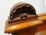 an old fashioned radio sitting on top of a wooden table