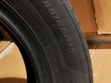 tires are stacked on top of a cardboard box in a room