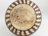 a brown and white bowl with a design on it