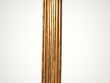 a tall gold column stands against a white background