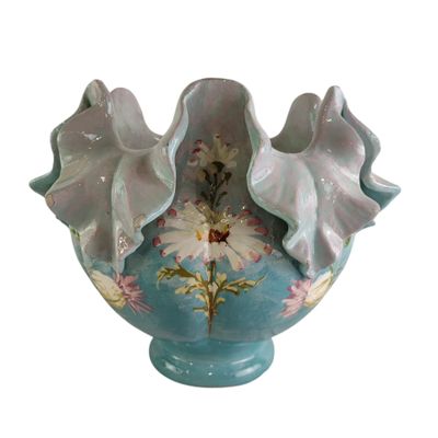 a blue and white vase with flowers in it