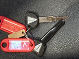two keys that are sitting on a car keychain