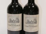 two bottles of wine sitting next to each other on a table