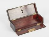 a small wooden box with a key in it