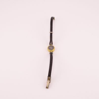 a close up of a watch on a white surface with a white background