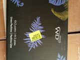 a black notebook with blue leaves on it sitting on top of a wooden table