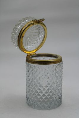 an image of a glass jar with a gold lid on a white background