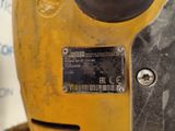 a close up of a yellow machine with a sticker on it
