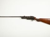 a rifle on a white background with a wooden handle