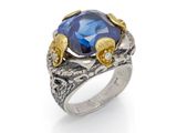 a close up of a ring with a blue stone on it